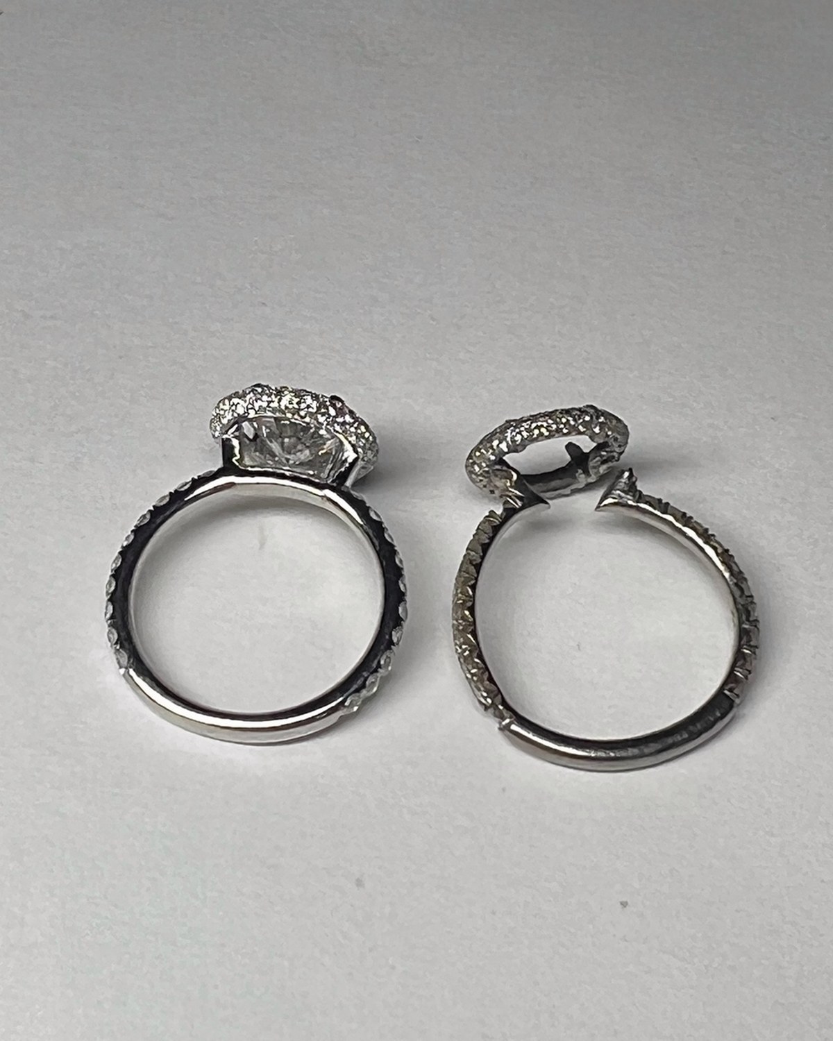 Contoured open-halo diamond wedding band, shaped to nest against the engagement ring
