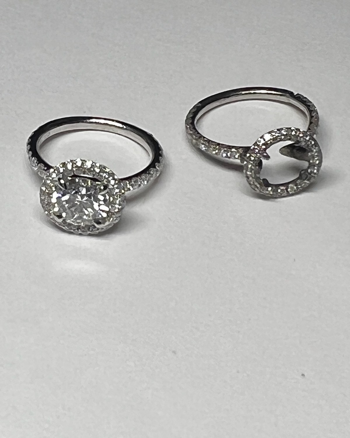 Round diamond in a pavé halo on a diamond-set shank, photographed alone