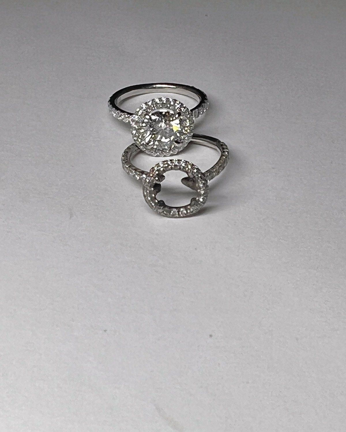 Round diamond halo engagement ring stacked inside its contoured wedding band, showing how the two sit flush