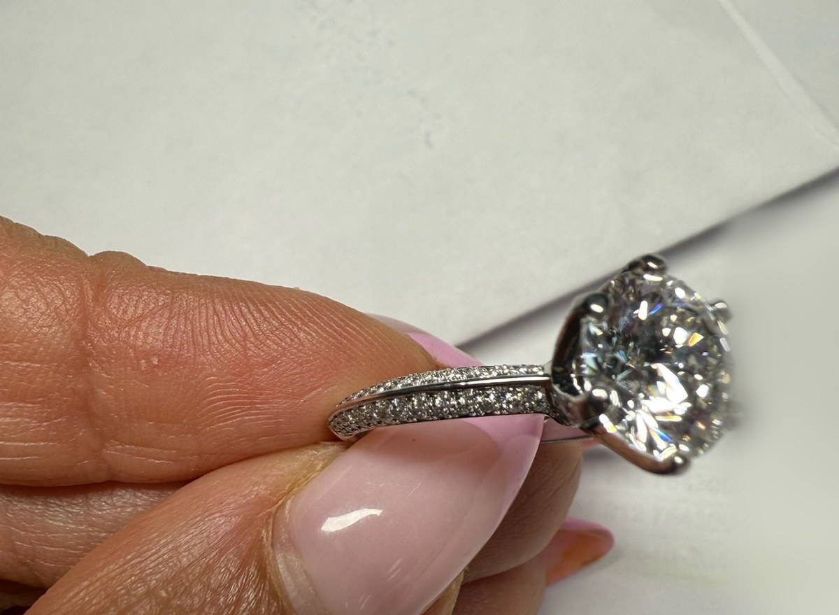 Profile macro of a round diamond solitaire in a six-prong head above a tapered micropavé shank